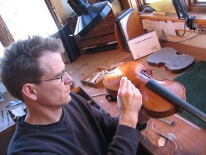 Folland working on a violin
